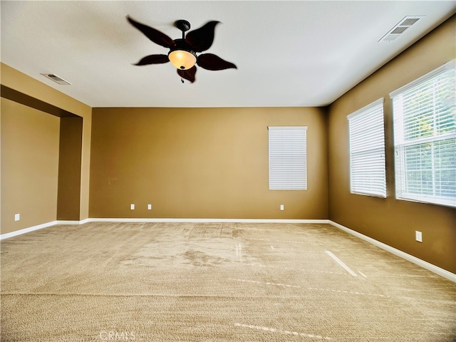 carpeted empty room featuring ceiling fan