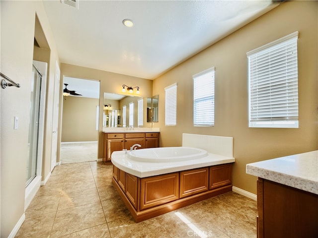 bathroom featuring vanity, tile patterned flooring, independent shower and bath, and ceiling fan