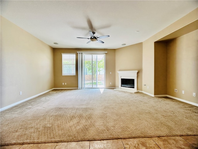 unfurnished living room with light carpet and ceiling fan