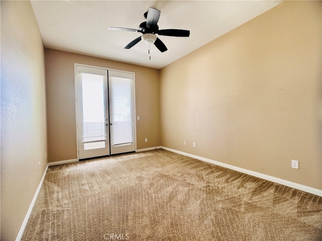 spare room with ceiling fan and light carpet