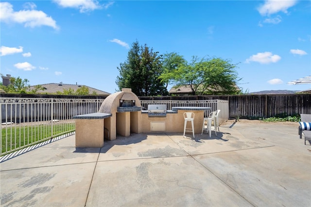 view of patio with area for grilling and an outdoor kitchen