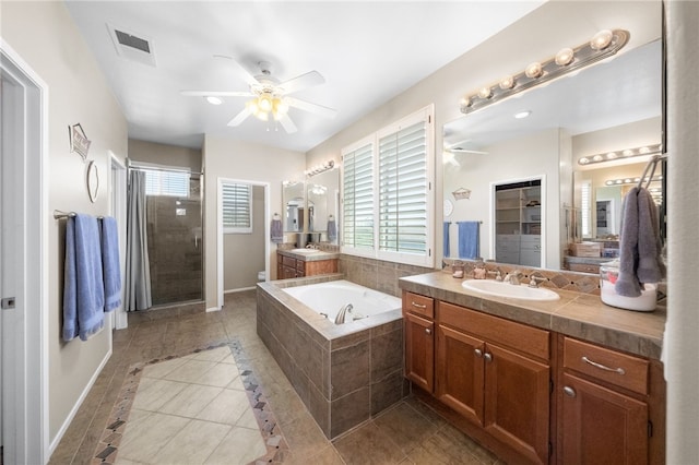 bathroom featuring tile patterned flooring, separate shower and tub, vanity, and ceiling fan