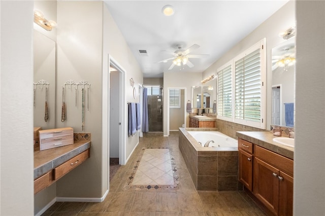 bathroom featuring ceiling fan, tile patterned flooring, vanity, and plus walk in shower