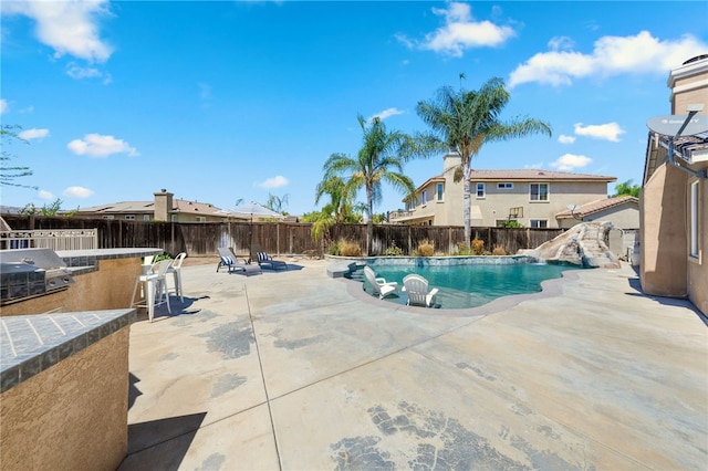 view of swimming pool featuring a grill and a patio area