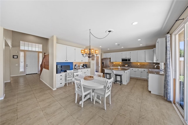 tiled dining area with an inviting chandelier and sink