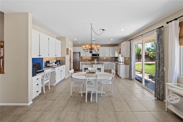 dining room with light tile patterned flooring, an inviting chandelier, and sink