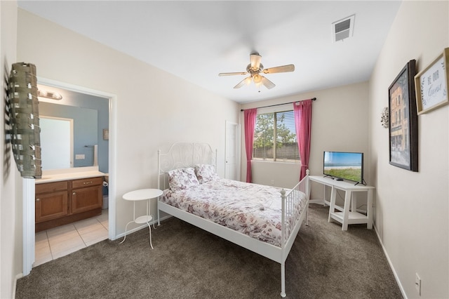 bedroom featuring ensuite bath, ceiling fan, and light colored carpet