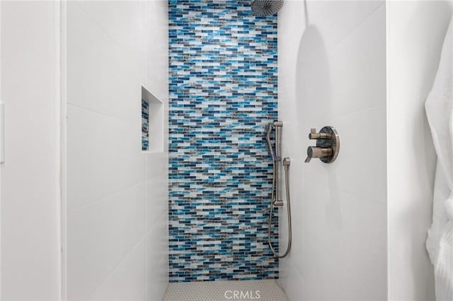 bathroom with tiled shower