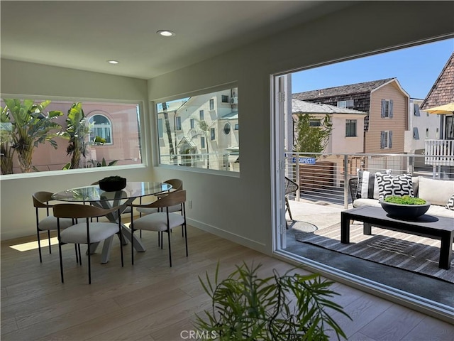 dining space with hardwood / wood-style floors