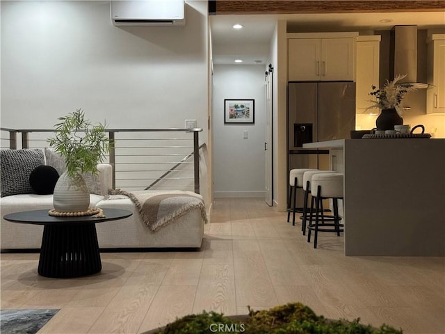 interior space featuring a wall mounted AC and light hardwood / wood-style flooring