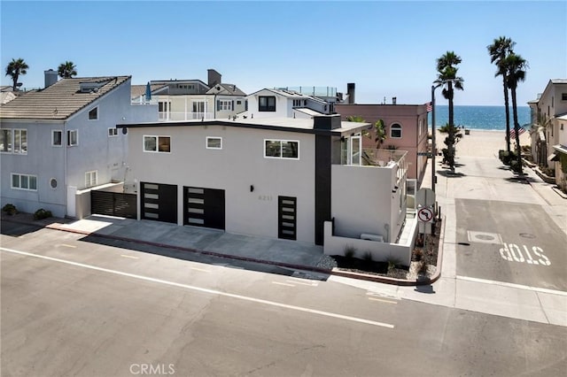 view of building exterior featuring a water view and a garage