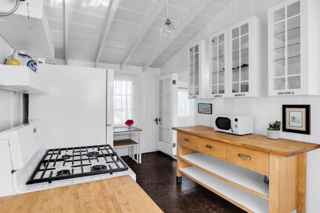 kitchen with butcher block countertops, white cabinets, lofted ceiling with beams, and white appliances