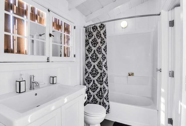 full bathroom with vanity, vaulted ceiling with beams, shower / bathtub combination with curtain, and toilet