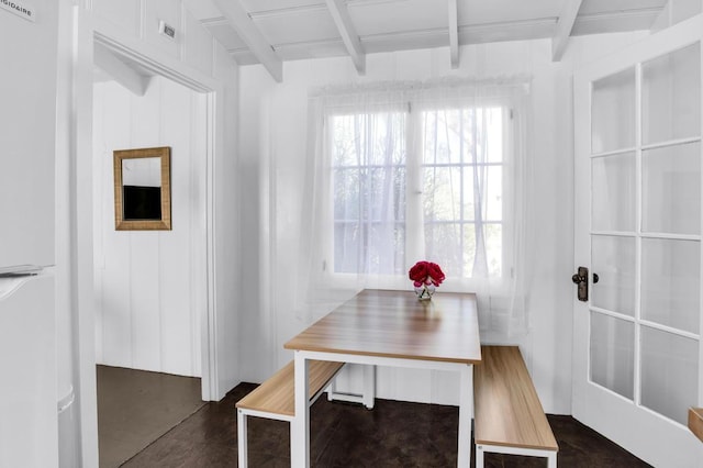 dining room featuring beamed ceiling