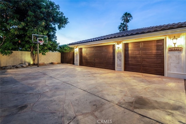 view of garage at dusk