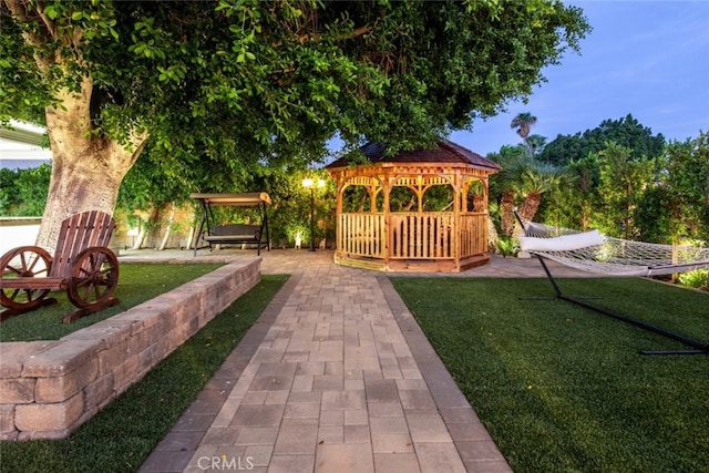 surrounding community featuring a lawn, a patio area, and a gazebo