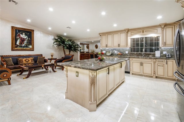 kitchen with tasteful backsplash, stainless steel appliances, a center island, dark stone countertops, and crown molding