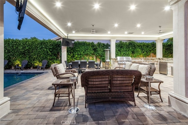 view of patio / terrace featuring an outdoor hangout area, area for grilling, and an outdoor kitchen