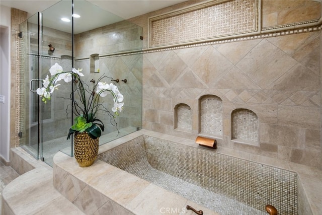 bathroom with tile walls and an enclosed shower