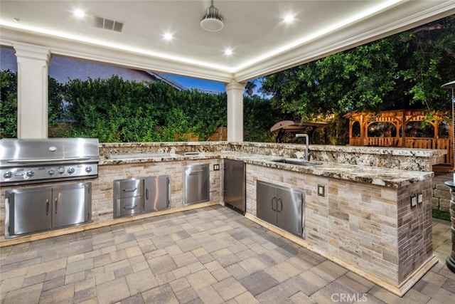 view of patio featuring area for grilling, an outdoor kitchen, and sink