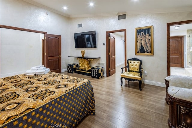 bedroom with wood-type flooring and crown molding