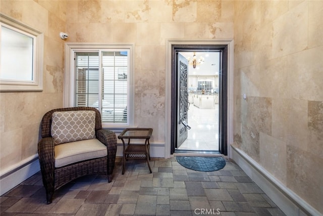 entryway with tile walls and a baseboard radiator