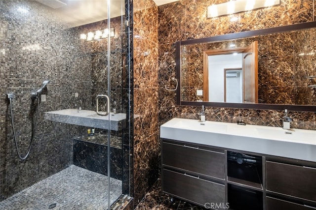 bathroom with tile walls, backsplash, an enclosed shower, and vanity