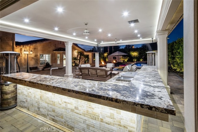 view of patio featuring area for grilling, ceiling fan, and an outdoor hangout area