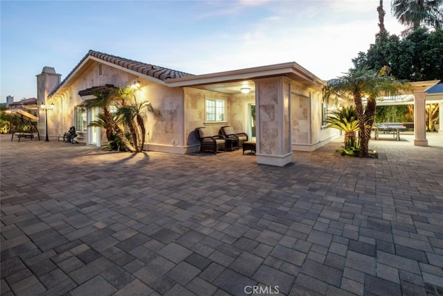 back of house with a patio and ceiling fan