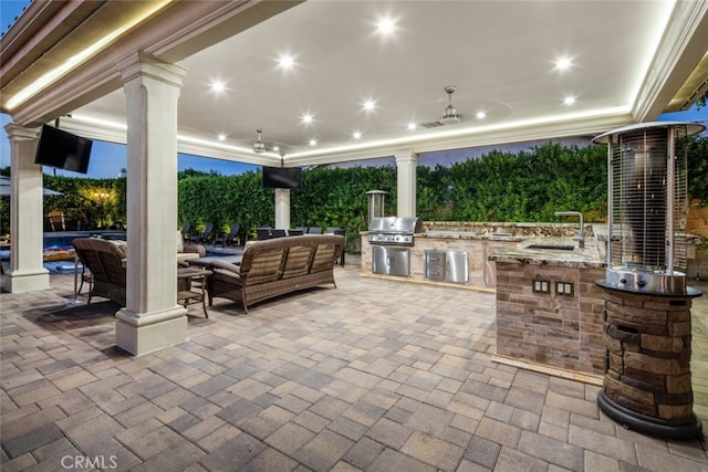 view of patio / terrace featuring exterior kitchen, area for grilling, ceiling fan, and sink