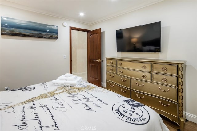 bedroom featuring wood-type flooring and ornamental molding