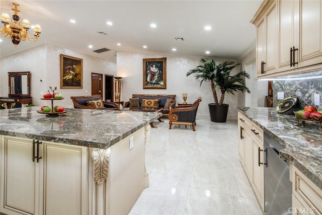 kitchen featuring ornamental molding, stainless steel dishwasher, cream cabinetry, a center island, and dark stone countertops