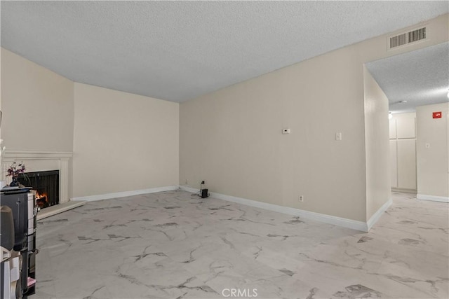 unfurnished living room featuring a textured ceiling