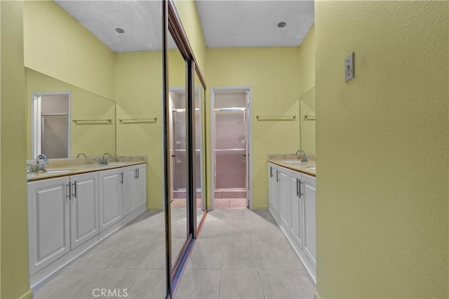 bathroom with tile patterned flooring and vanity