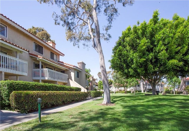 surrounding community featuring a yard and a residential view
