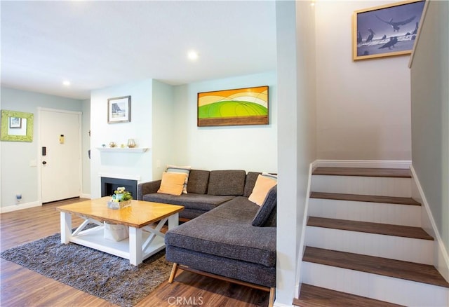living area featuring stairs, wood finished floors, recessed lighting, and baseboards