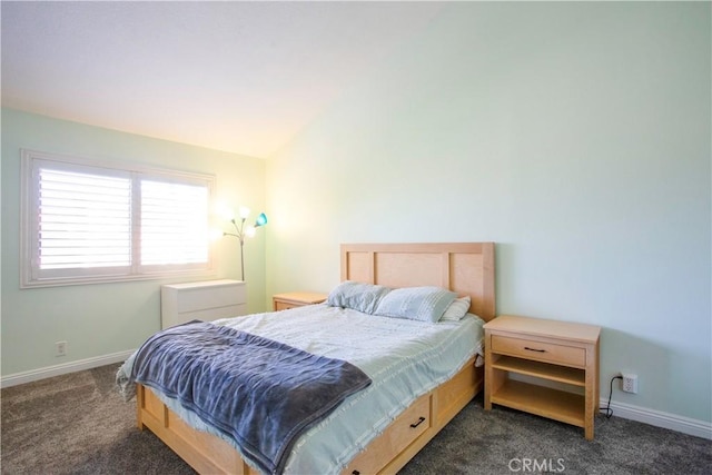 bedroom with dark carpet, baseboards, and vaulted ceiling