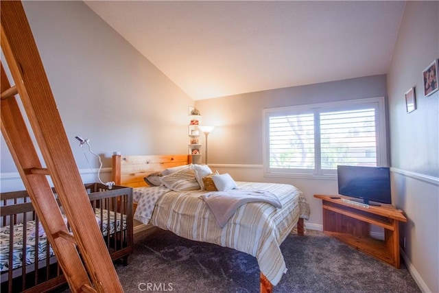 bedroom with carpet floors, vaulted ceiling, and baseboards