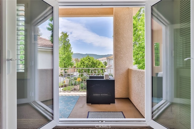 doorway to outside with a mountain view