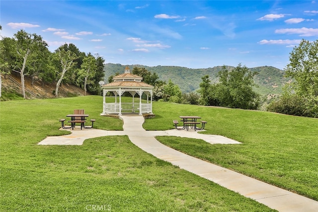 surrounding community featuring a lawn, a gazebo, and a mountain view