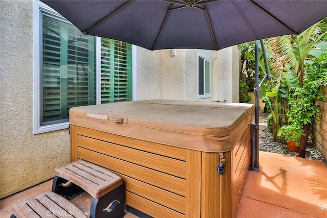 wooden terrace with a hot tub