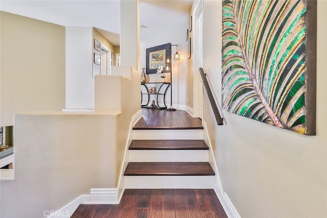 stairs featuring hardwood / wood-style flooring