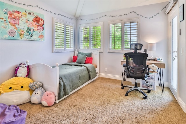 bedroom with beam ceiling and carpet flooring