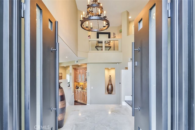 foyer entrance with an inviting chandelier