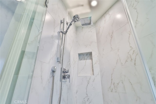 bathroom with tiled shower