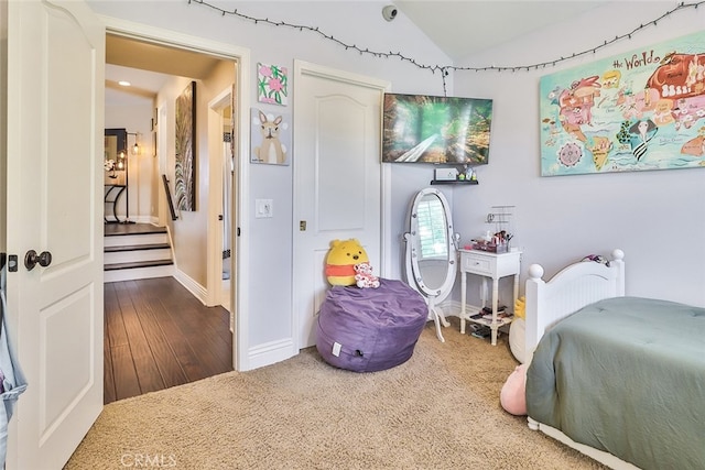 bedroom featuring wood-type flooring and lofted ceiling