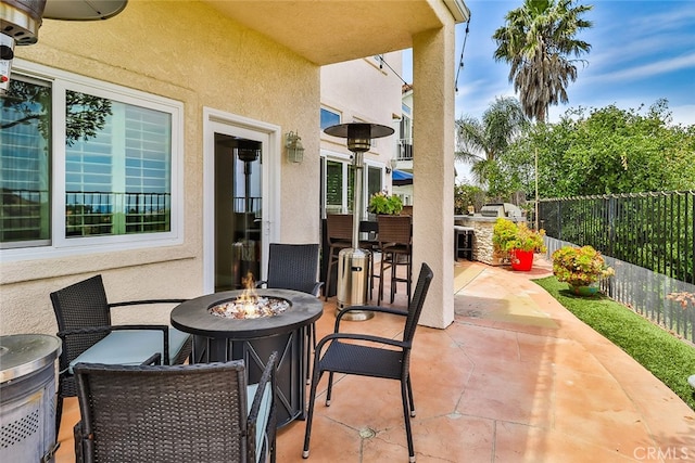 view of patio featuring an outdoor fire pit