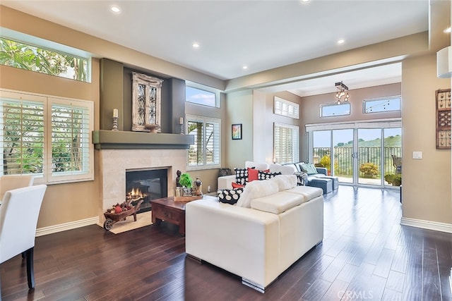 living room with dark wood-type flooring and a healthy amount of sunlight