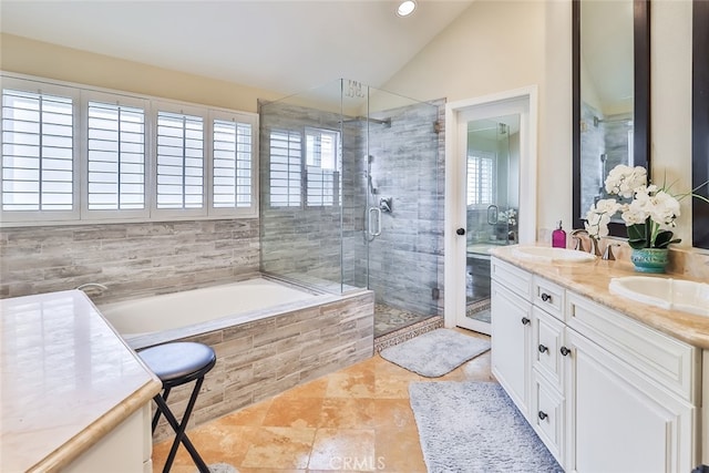 bathroom with tile patterned flooring, shower with separate bathtub, lofted ceiling, and vanity