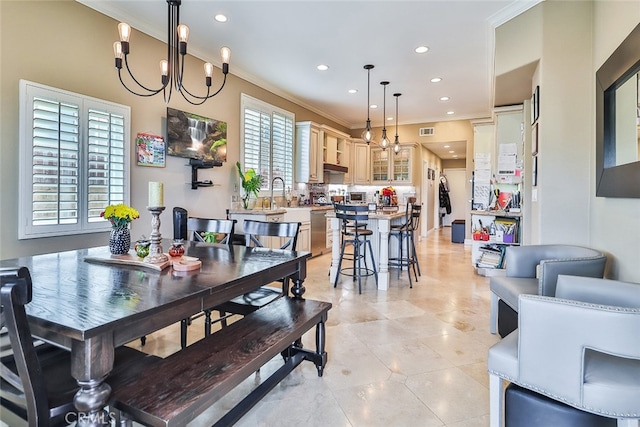 tiled dining room featuring ornamental molding and an inviting chandelier